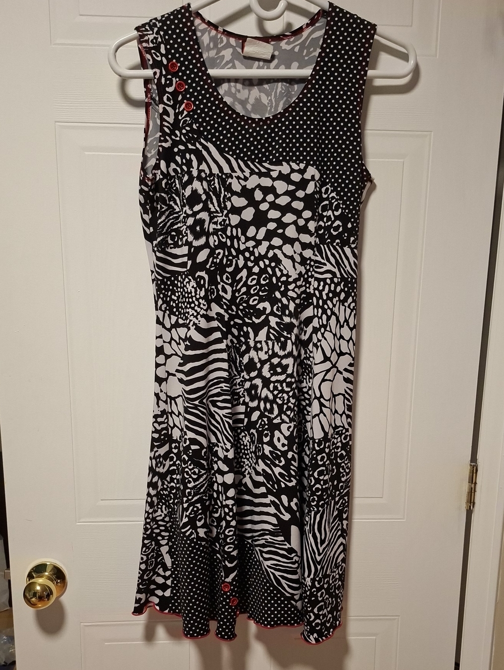 Sleeveless Black & White Mixed-Print Midi Dress with Red Button Accents